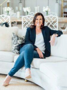 Robyn Marie, certified life coach for women and teens, sitting confidently on a white sofa in a bright, welcoming space.
